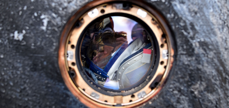 View of Mikhail Kornienko through the window of the Soyuz-TMA-18M. (Image by Krill Kudryavtsev/Pool Photo via AP)